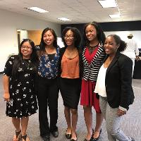 a group of women standing together for a group photo