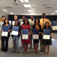 a group of students holding up awards