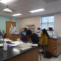 several students paying attention in class to a teacher