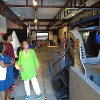 several people stand near a simulation machine