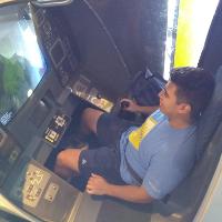 a male student sitting in a simulation cockpit