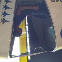 a male student sitting in a simulation cockpit, looking at the screen