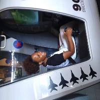 a female student sitting in a simulation cockpit