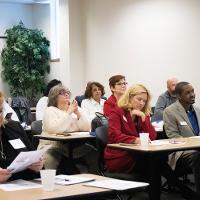 several faculty watching a presentation