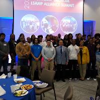several people posing on a stage