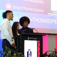 several people standing at a podium talking