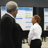 a female student discussing a presentation with another person