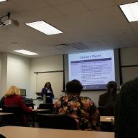 several people watching a presentation on a projector