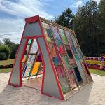 Sculpture of stained glass in the shape of a 3 dimensional triangle