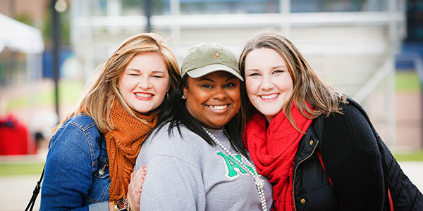 Alexis Knox posing with two other people