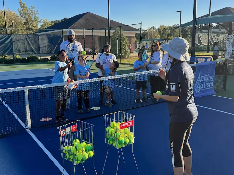 Columbus State University playing tennis with Aceing Autism students
