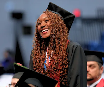 A female student in her cap and gown at graduation