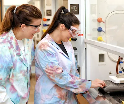 Two science students working in a lab