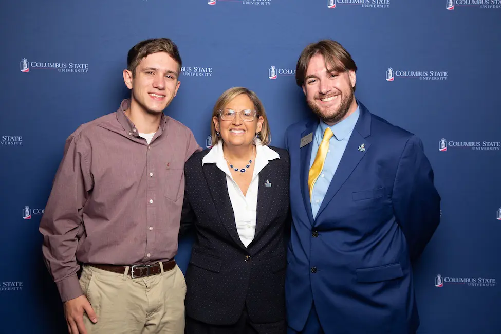 Three people posing for photo