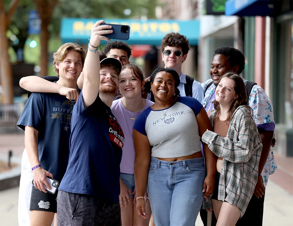 Students posing for a selfie downtown