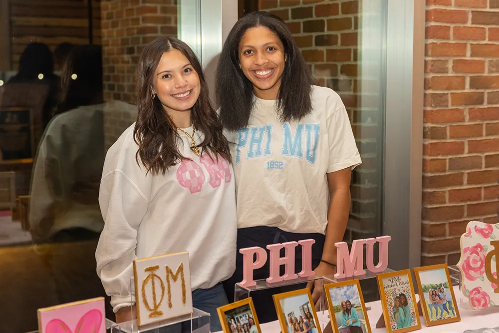 Two sorority girls representing Phi Mu