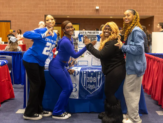 Zeta Phi Beta students posing at a greek life event
