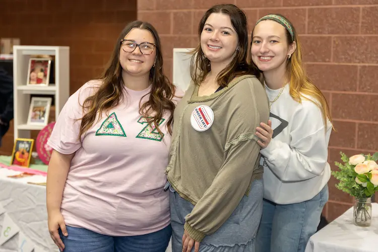 Phi Mu students posing at a greek life event