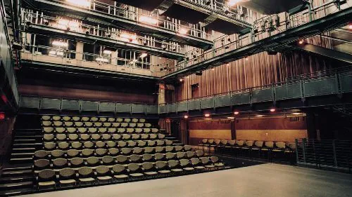 Empty Studio Theater at the RiverCenter, with rows of seats facing the stage.