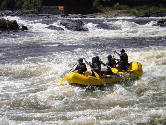 Five students and a guide on a Whitewater raft on the Chattahoochee River