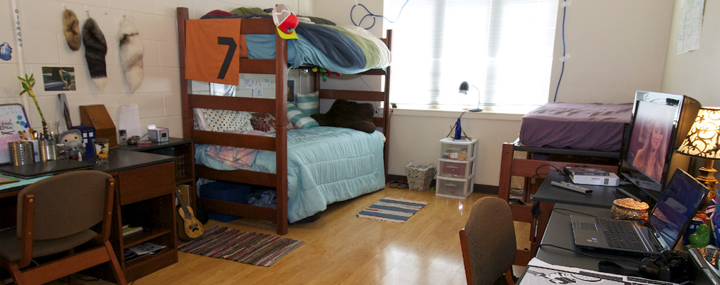 Broadway Crossing triple occupancy bedroom with two bunk beds, one loft bed, and three desks