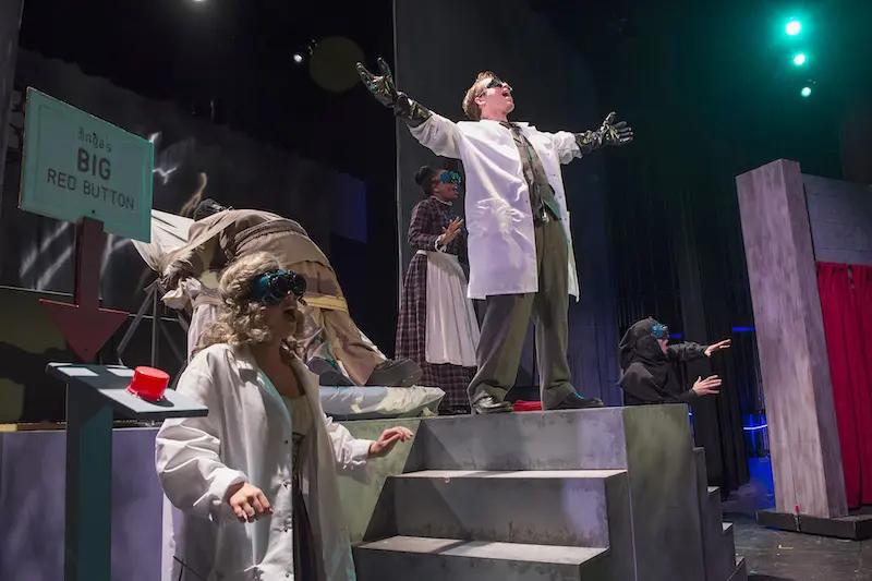 students on stage singing during a performance