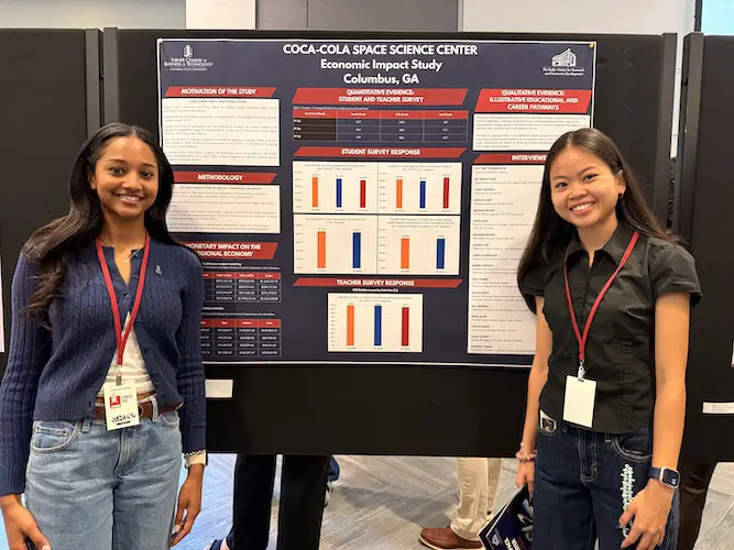 Jordan Mills and Nhi Do standing with their presentation poster at Tower Day 2026