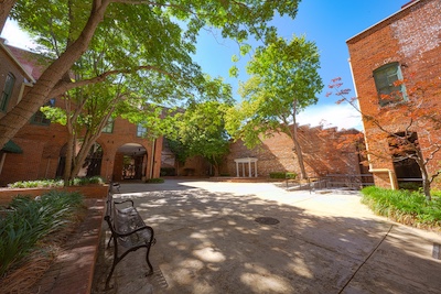 courtyard with green trees, blue sky