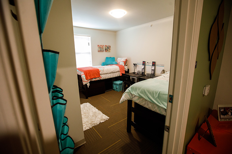 a dorm room with two beds